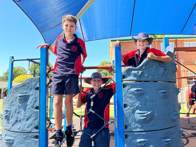 Three students on the play equipment.