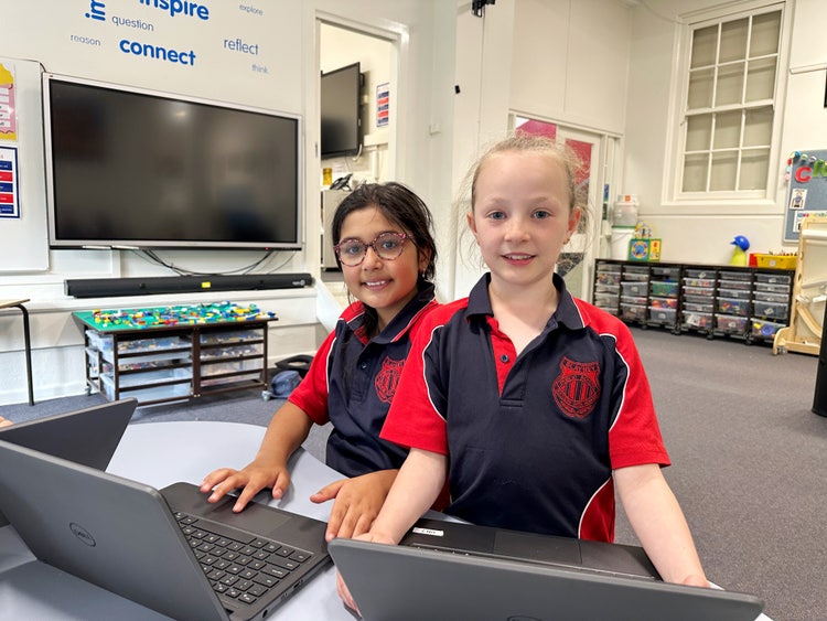 Two students working on laptops.