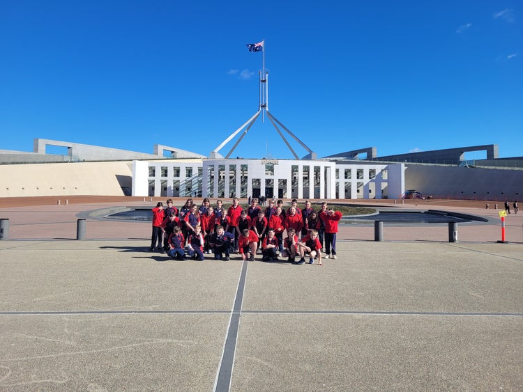A group of students in front of Parliament House in Canberra.